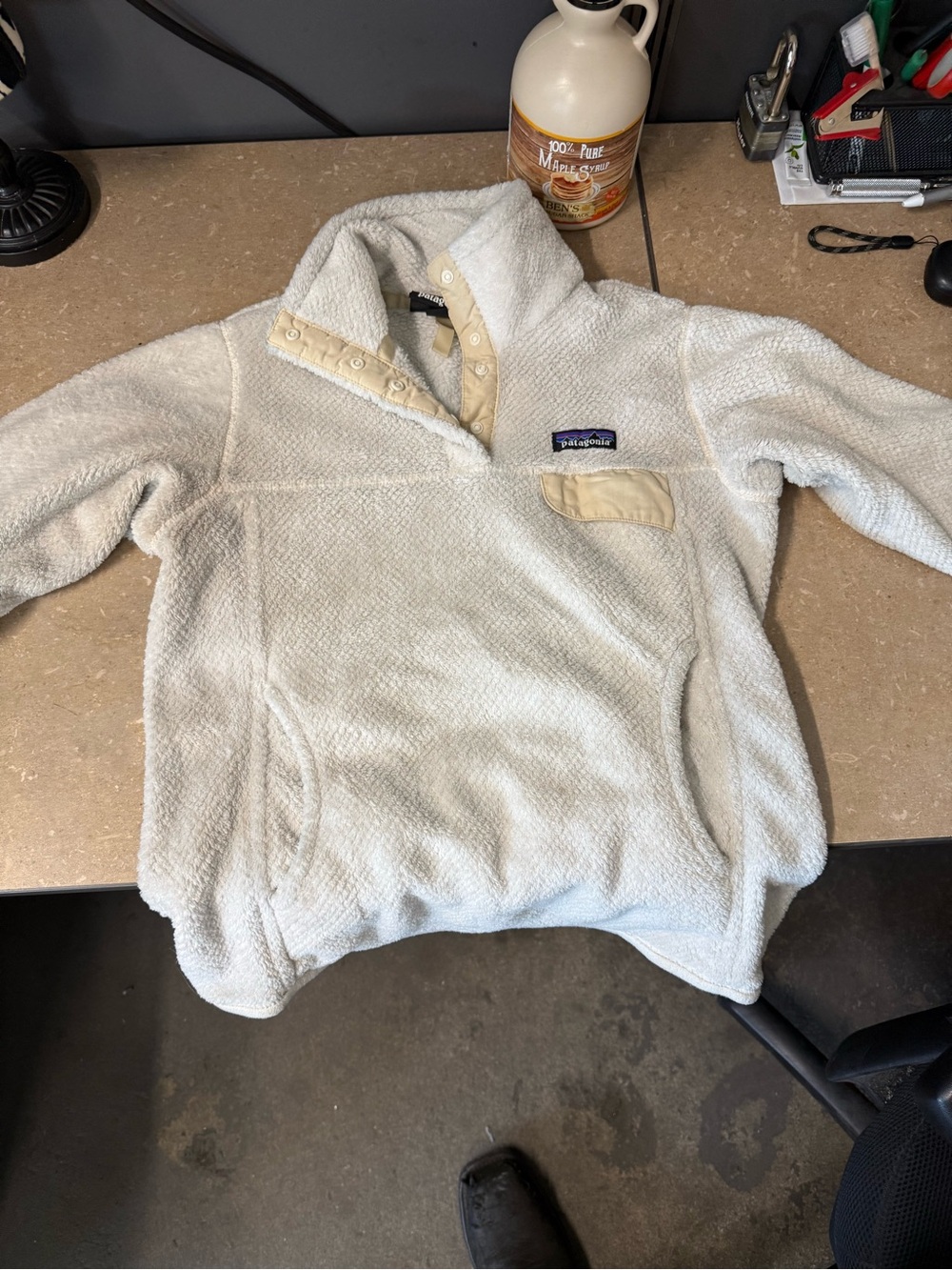 Patagonia black label with blue and purple mountain logo on cream fleece